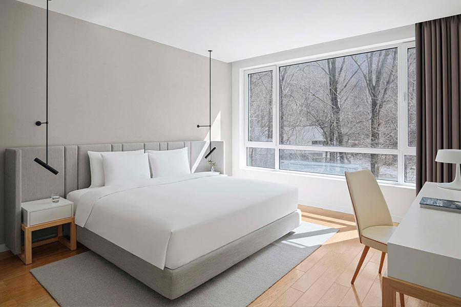 Minimalist hotel furniture collection, featuring sleek designs for guest room spaces. Perfect for modern, understated luxury hospitality interiors.